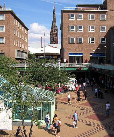 Coventry precinct with spire of ruined cathedral in the background, part of the post-war redevelopment of the city centre
