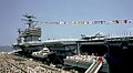Crew members man the rails aboard the nuclear-powered aircraft carrier USS GEORGE WASHINGTON (CVN-73) during the vessel's commissioning ceremony. An F-14A Tomcat aircraft is parked - DPLA - 8020e3e3d063394de4d274de9ba74e28.jpeg