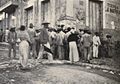 Discussing the surrender of Santiago on a street corner