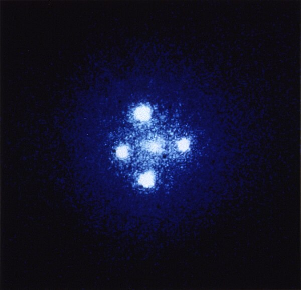 Seen through a telescope, the Einstein cross seems to provide evidence for five different objects, but this observation is theory-laden. If we assume 