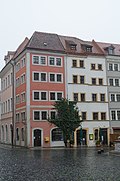 Residential building with shop in closed development, corner house