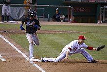 New York Mets' Jose Reyes points to the sky crossing the plate