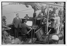 Irish American tenor singer John McCormack (1884-1945) singing on the "Surf", Harriss sitting with folded arms by the piano McCormack on "Surf" LOC 29086339465.jpg