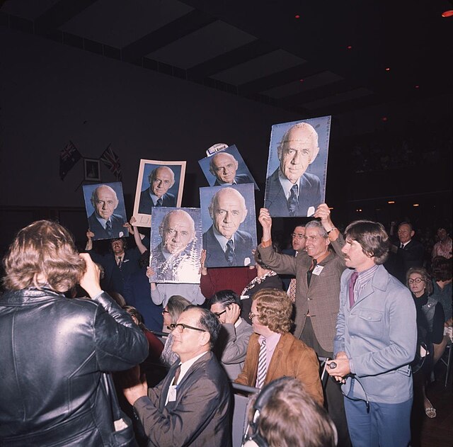 Supporters of McMahon hold up his placards at a rally during the election.