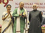 Mohd. Hamid Ansari presented the Dadasaheb Phalke Award 2011 to Shri Soumitra Chatterjee, at the 59th National Film Awards function, in New Delhi. The Union Minister for Information and Broadcasting, Smt. Ambika Soni (cropped).jpg