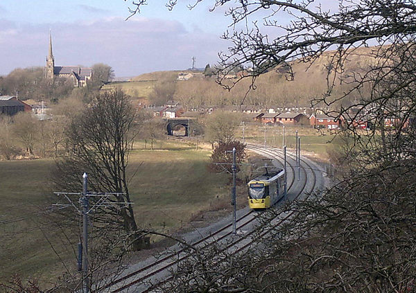 A tram running on the line between Shaw and Crompton, and Newhey.