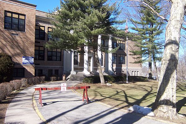 The original high school building, showing the Broad Avenue facade and the southeast corner extension on the left side