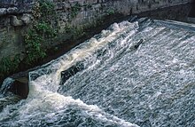 Fish ladder for Atlantic salmon constructed to allow Atlantic salmon and Sea-trout to navigate over a weir Original Fish Pass on the dock feeder weir Port Talbot.jpg