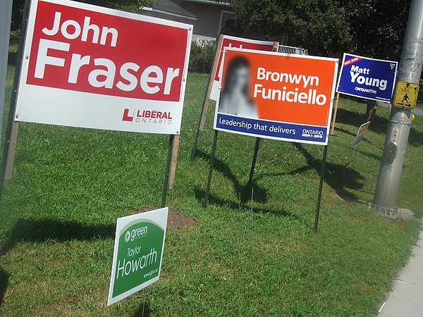 Election signs for John Fraser (Liberal), Taylor Howarth (Green), Bronwyn Funiciello (NDP) and Matt Young (PC)