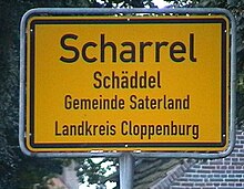 A bilingual sign, with the second line showing the place name in Saterland Frisian