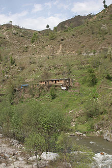 A view of Siran Valley with houses on the mountain side with the River Siran flowing below.