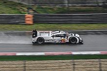 Webber driving his Porsche 919 Hybrid on a sodden track surface at the Shanghai International Circuit in China