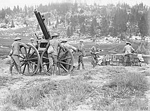 Gunners of the Royal Artillery laying and loading a 13-pounder (9 cwt) anti-aircraft gun in Italy, 1918. QF 13 pounder 9 cwt AA gun on field mounting WWI IWM Q 26829.jpg