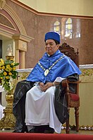 The Rector Magnificus of the University of Santo Tomas in Manila, Philippines, in full Spanish academic attire, wearing the academic biretta and the mozetta over the Dominican habit