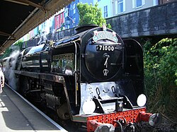 BR Standard Class 8 Locomotive 71000 Duke Of Gloucester arrives at Kingswear railway station in August 2011 as the Torbay Express. Torbay Express at Kingswear 2.jpg