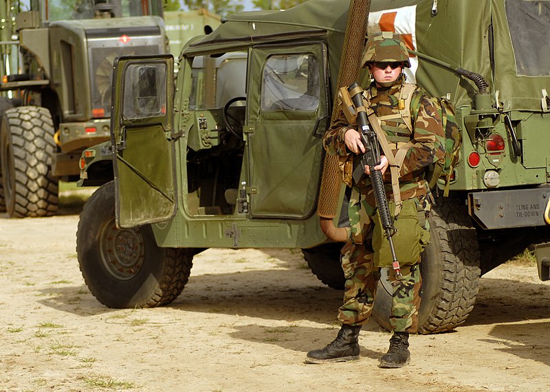 File:US Navy 070619-N-3857R-007 Personnel Specialist 3rd Class Ray Guedry, of Naval Mobile Construction Battalion (NMCB) 1, guards the ambulance while others secure a perimeter during Operation Desert Heat, a graded field exercise.jpg