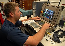 A U.S. Navy Explosive Ordnance Disposal Technician trains on iRobot's PCC, one of the remote control operation devices used to operate the Packbot. US Navy 090624-N-4649C-002 A Sailor operates a PackBot explosive detecting robot during explosive handling training at U.S. Coast Guard Station Quillayute River, Wash.jpg