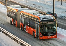 An electric articulated Volvo 7900 operated by HSL in Vantaa, Finland. Volvo 7900 Electric Articulated HSL bus 570 to airport on Valkoisenlahteentie, Jokiniemi, Vantaa, Finland, 2022 December.jpg