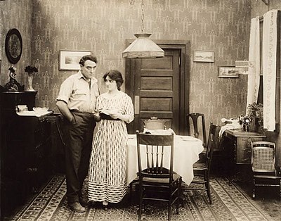 Unemployed worker John Adams (Willard Mack) and his wife (Clara Williams) are faced with bills they cannot pay in a still from The Corner (1916).