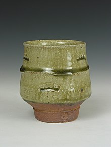 A Yunomi or tea cup with an ash glaze, pooling at the horizontal ridges, made from pine ash by Phil Rogers. Yunomi ash.jpg