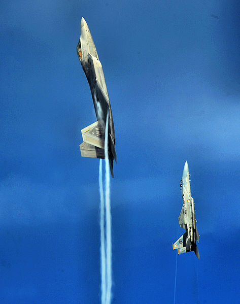 An F-22A Raptor and F-15C Eagle from the U.S. Air Force Weapons School's 433rd Weapons Squadron pull into a vertical climb over the Nevada Test and Tr