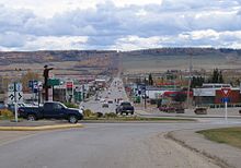 Looking south past traffic circle down 8 Street, with the metal statue pointing the way northwest to Alaska.