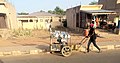 A Street Trader Pushing hid Aluminum wares.jpg