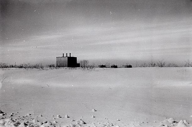 The deserted heating plant and POL storage tanks during the first winter after the base was cancelled.