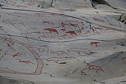 English: Rock art in the world heritage area in Alta, Norway. This is from the area Bergbukten 1, a group of some 900 figures. 23-25 m above sea level, and 6000-7000 years old.