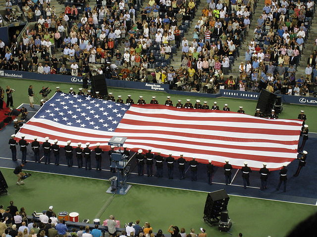 The American flag being unfurled at the opening ceremony