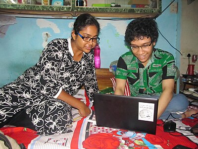Ananya Mondal is showing a new user (Arnab Bar) how to create an account in Wikipedia.