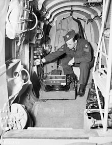 Sergeant of No. 14 (P) Squadron, RCAF, installing a vertical camera in an Avro Anson V, Rockcliffe, Ont., 4 July 1944 AvroAnsonCameraInstallJuly1944.jpg