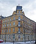 Apartment house in a corner and closed development