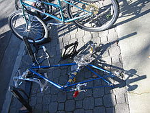 An attempted bicycle theft in Davis, California where the perpetrator tried to the break the U-lock with a car jack Bike lock cracked by jack overview.jpg