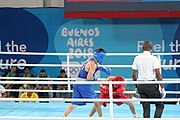 Deutsch: Boxen bei den Olympischen Jugendspielen 2018 Tag 12, 18. Oktober 2018 - Finale im Leichten Weltergewicht Jungen – Ilia Popov (Russland, rot) schlägt Talgat Shaiken (Kasachstan, blau) 4-1; Ringrichter ist James Beckles (Trinidad und Tobago). English: Boxing at the 2018 Summer Youth Olympics on 18 October 2018 – Final Light Welterweight Boys Bout - Ilia Popov (Rusia, rojo) supera a Talgat Shaiken (Kazajstán, azul) 4-1; Referee is James Beckles (Trinidad and Tobago). Español: Boxeo en los Juegos Olímpicos Juveniles de Verano de 2018 en 18 de octubre de 2018 - Chicos de peso welter ligero final: Ilia Popov (Uzbekistán, roja) le gana a Talgat Shaiken (Egipto, azul) 4-1; El árbitro es James Beckles (Trinidad y Tobago).