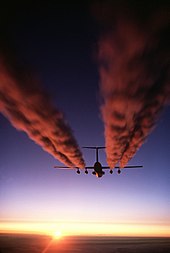 A C-141 Starlifter leaves a vapor trail over Antarctica