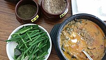 Chueo-tang (loach soup) served with chopi powder, perilla powder, and garlic chives Chueotang chopi (Zanthoxylum piperitum) deulkkae (Perilla frutescens) buchu (Allium tuberosum).jpg