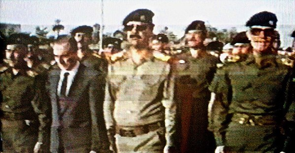 El Aissami's great-uncle, Shibli al-Aysami, in a suit beside Saddam Hussein in July 1989.