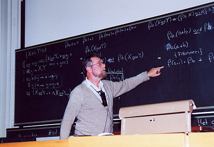 Dijkstra at the blackboard during a conference at ETH Zurich in 1994. He once remarked, "A picture may be worth a thousand words, a formula is worth a thousand pictures."[18]