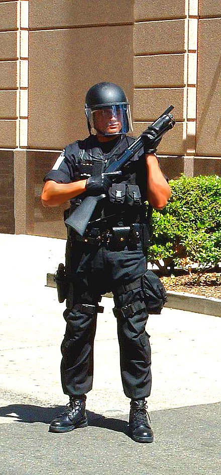 A U.S. Federal Protective Service officer in the early 2000s, equipped with full tactical gear and a shotgun