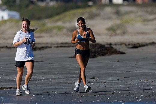 Women jogging along Morro Strand State Beach, California, U.S.