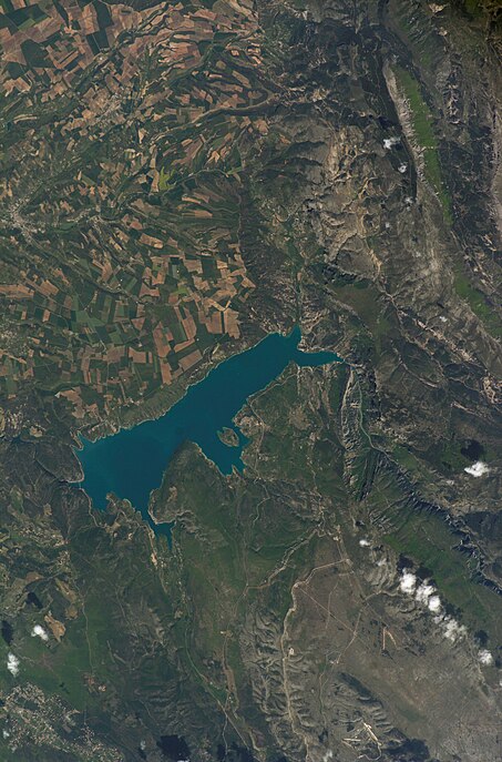 Lake Lac de Sainte-Croix (France), agricultural fields, Verdon River and Gorges du Verdon with rocks, village Moustiers-Sainte-Marie