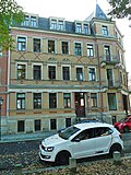 Apartment house in a corner and closed development