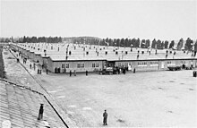 Aerial view of long, low, densely-packed buildings