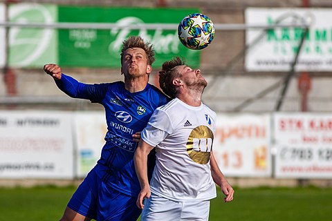 Players of SK Jiskra Rýmařov (away; blue jersey) and SK Dětmarovice (home; white jersey) in head-to-head ball match