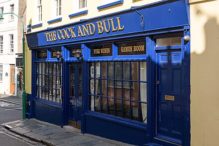 Local pubs and licensed premises not serving food (including the Cock and Bull, pictured) were forced to close on 20 March; all food-serving establishments were closed soon after. St-Peter Port, Guernesey (48030518077).jpg