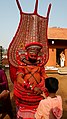 Theyyam at Andaloor kavu interacting with young devotee