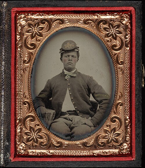 Image: Three quarter portrait, young Civil War soldier in kepi. Cased tintype, ninth plate