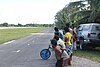 Tuvaluan kids watching plane land at Funafuti International Airport