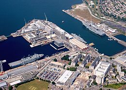 Photo of the core of HMNB Devonport, with several ships alongside, in 2005: No.5 Basin (left), Weston Mill Lake and what is now RM Tamar (right), Fleet Maintenance Base and Submarine Refit Complex (top), HMS Drake fleet accommodation centre (bottom) UK Defence Imagery Naval Bases image 14.jpg